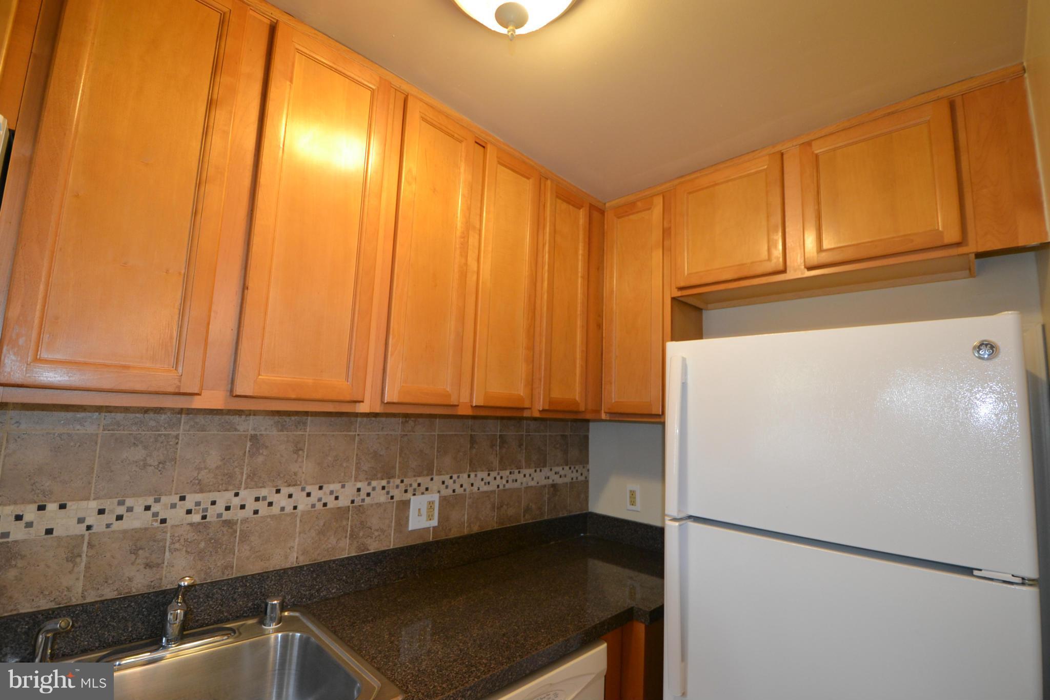 2504 Steele Road Baltimore, MD 21209 - Photo 8 of 21 a view of kitchen with refrigerator stove and cabinets