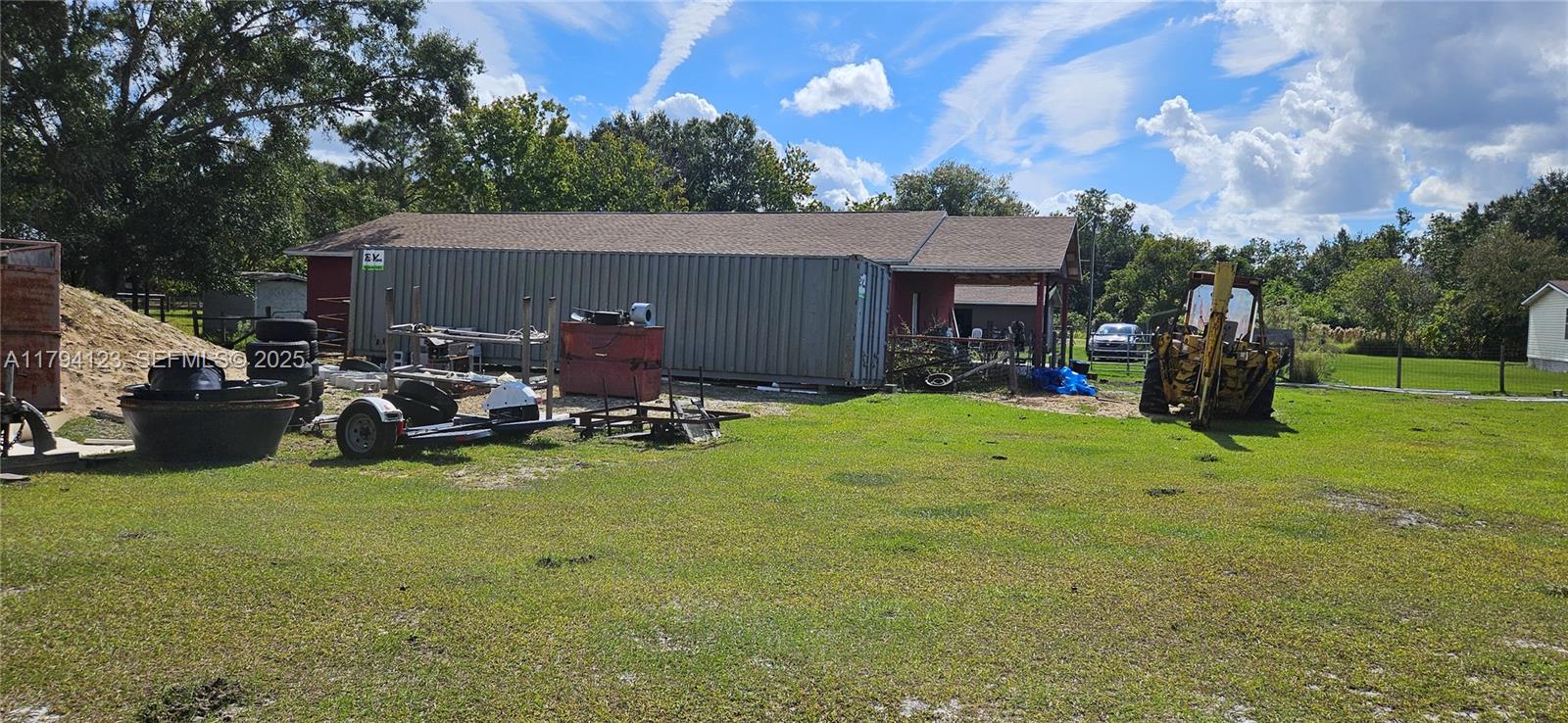 3100-3112 Sanders Road Davenport, FL 33837 - Photo 17 of 100 a view of a backyard with table and chairs and a fire pit