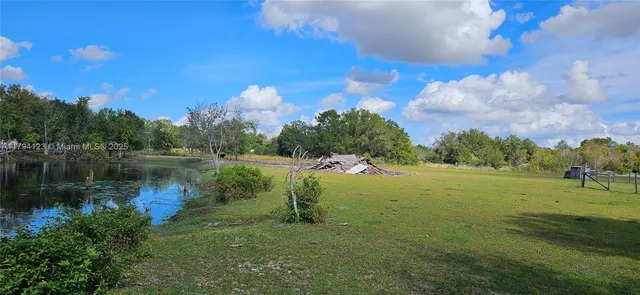 a backyard of a house with lots of green space and outdoor seating