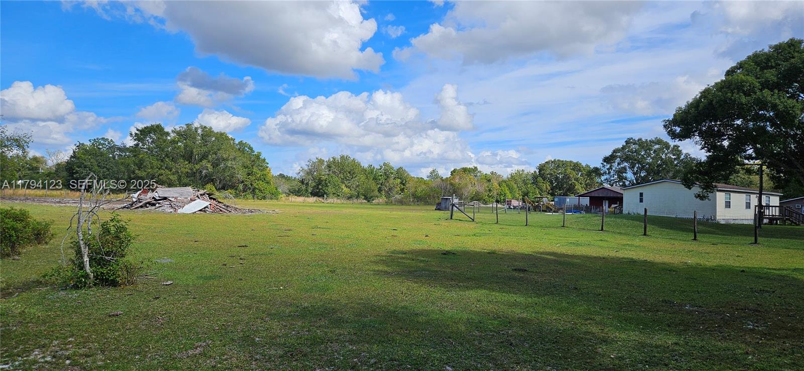 3100-3112 Sanders Road Davenport, FL 33837 - Photo 28 of 100 a view of grassy field with trees
