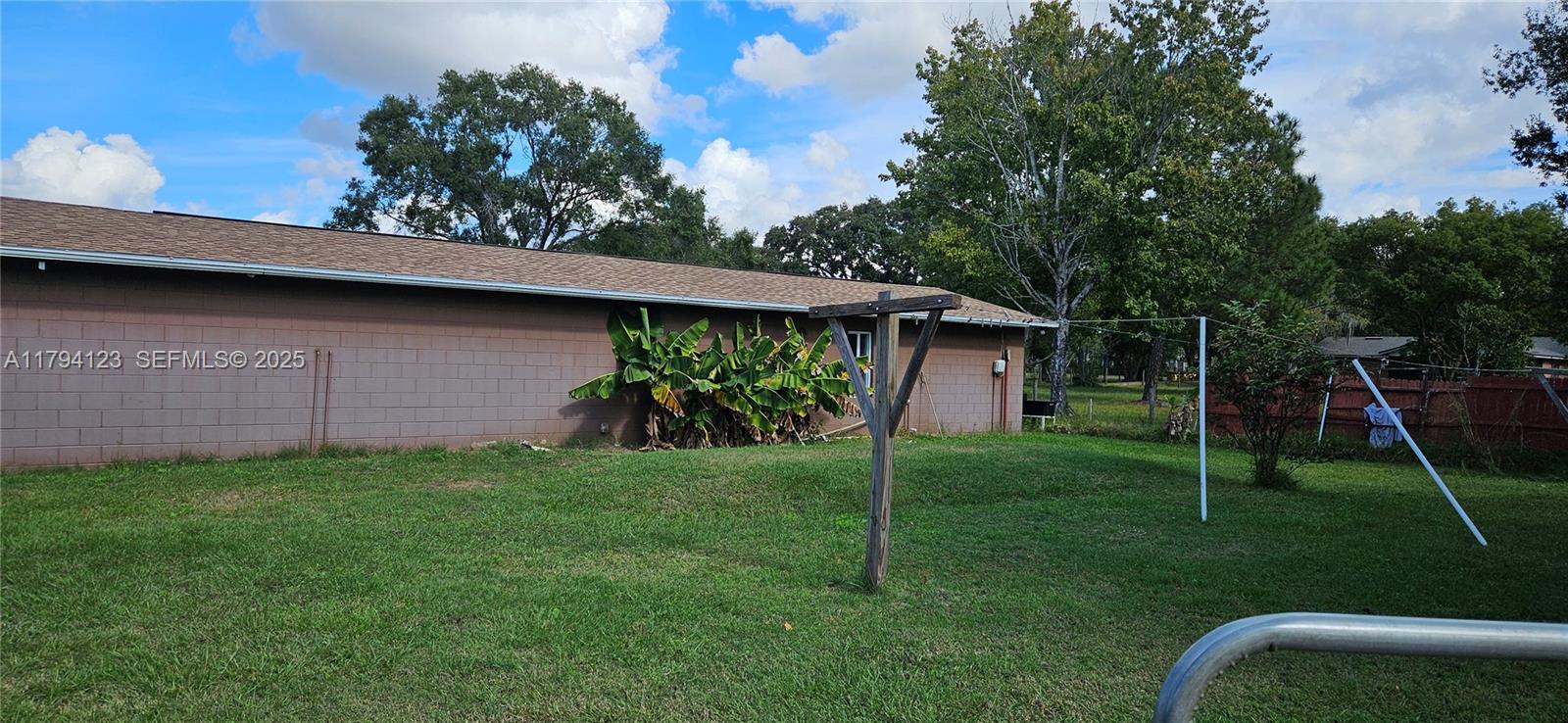 3100-3112 Sanders Road Davenport, FL 33837 - Photo 32 of 100 a backyard of a house with plants and wooden fence
