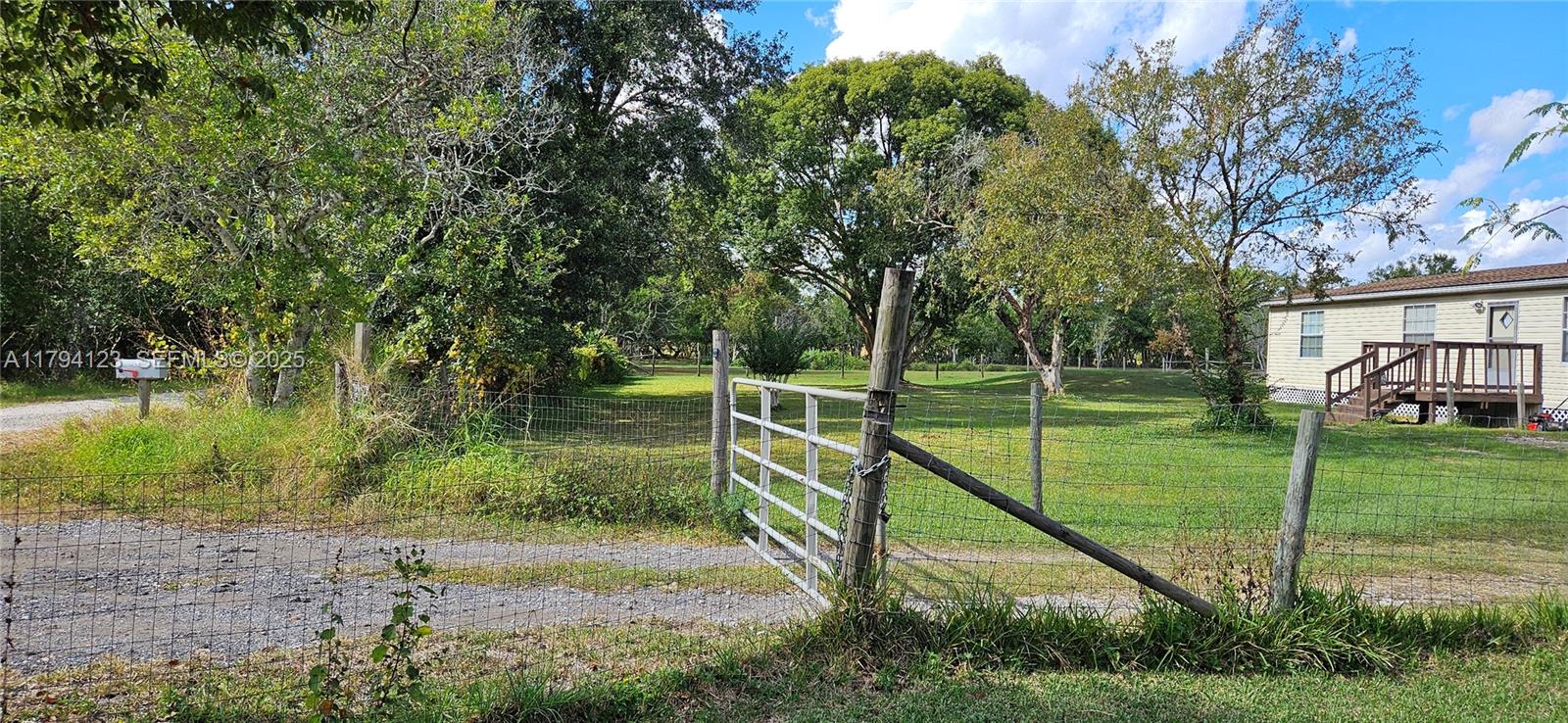 3100-3112 Sanders Road Davenport, FL 33837 - Photo 34 of 100 a view of a house with a big yard and potted plants