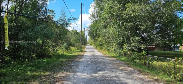 an empty room with a window and a ceiling fan