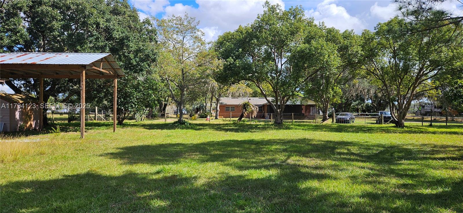 3100-3112 Sanders Road Davenport, FL 33837 - Photo 49 of 100 a view of a house with a big yard and large trees