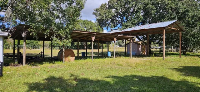 an aerial view of residential houses with outdoor space and parking