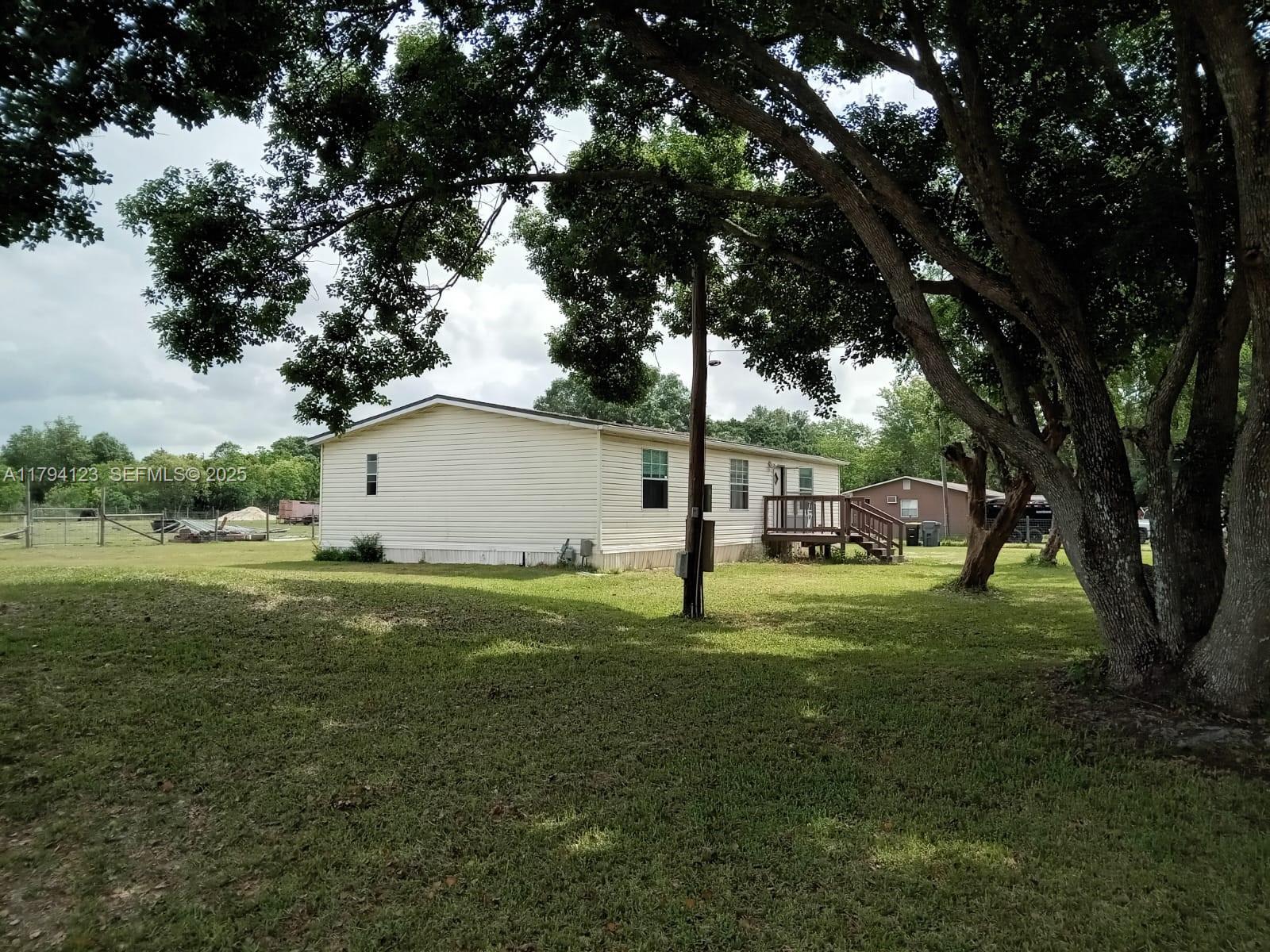 3100-3112 Sanders Road Davenport, FL 33837 - Photo 54 of 100 a backyard of a house with lots of green space and outdoor seating