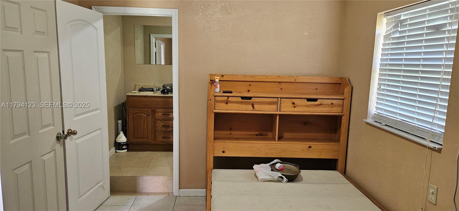 3100-3112 Sanders Road Davenport, FL 33837 - Photo 60 of 100 a bathroom with a sink and a mirror