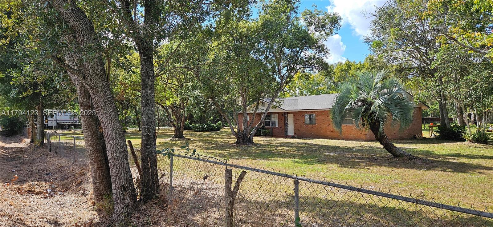 3100-3112 Sanders Road Davenport, FL 33837 - Photo 6 of 100 a view of a house with backyard and trees