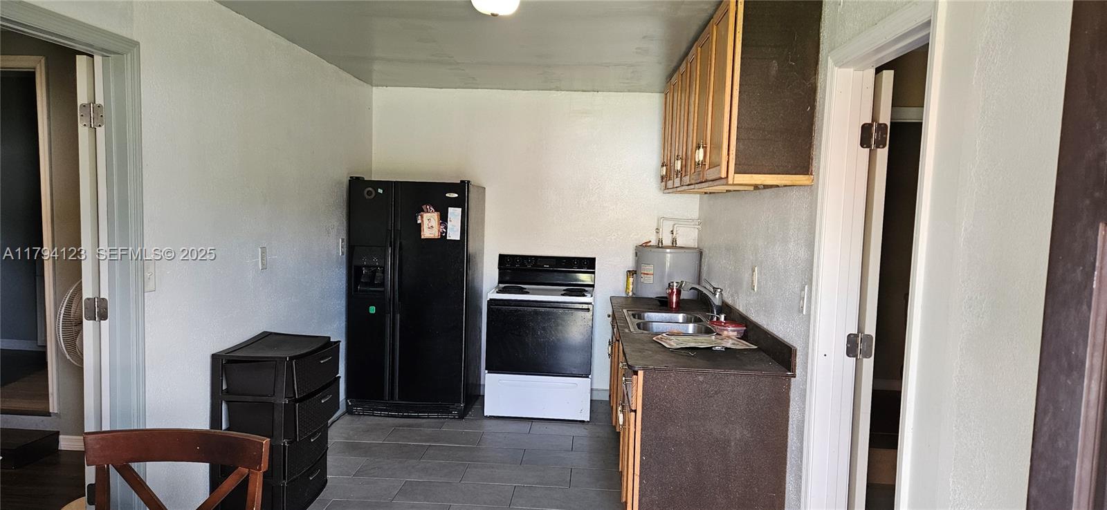 3100-3112 Sanders Road Davenport, FL 33837 - Photo 61 of 100 a kitchen with stainless steel appliances granite countertop a refrigerator and a stove
