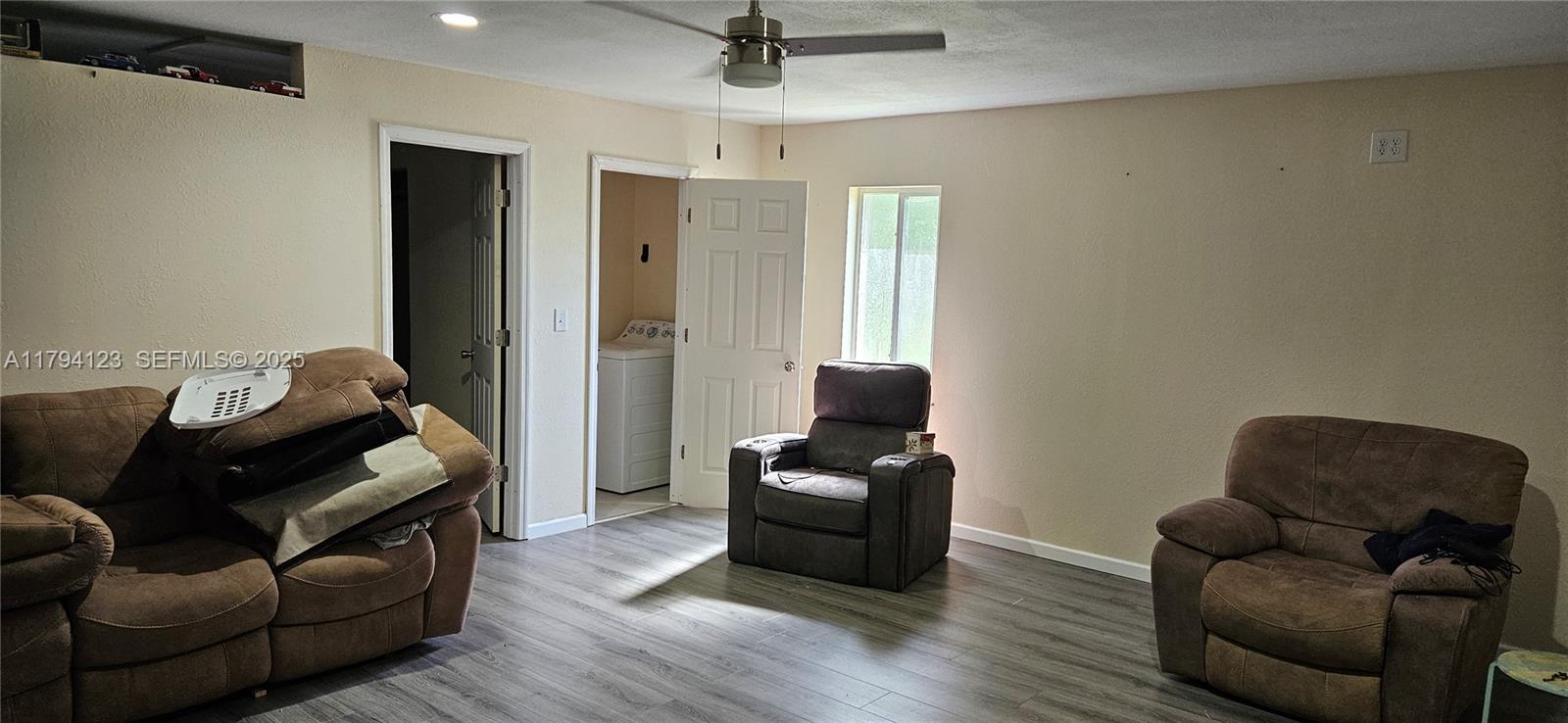 3100-3112 Sanders Road Davenport, FL 33837 - Photo 65 of 100 a living room with furniture and a flat screen tv