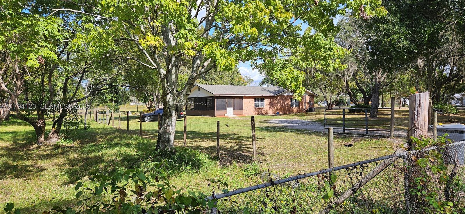 3100-3112 Sanders Road Davenport, FL 33837 - Photo 8 of 100 a swimming pool with outdoor seating and yard