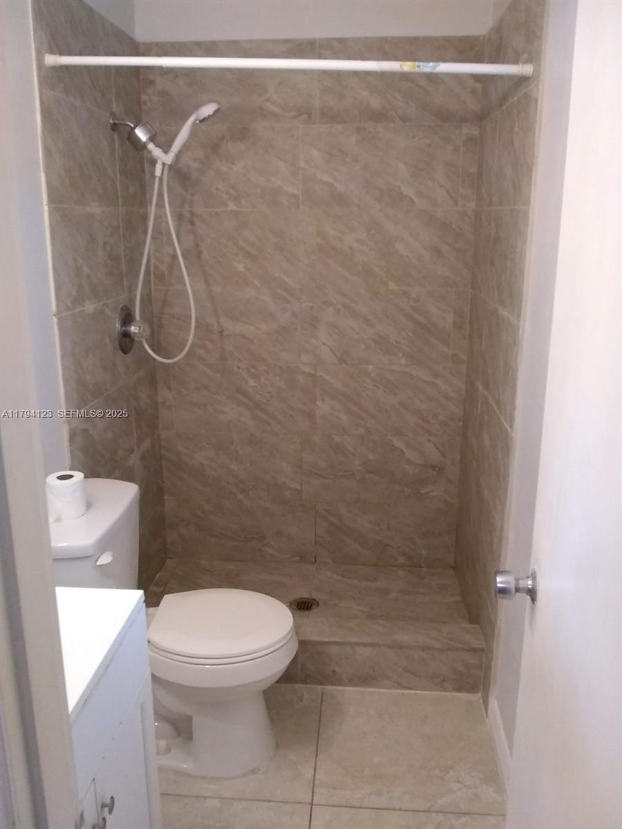 3100-3112 Sanders Road Davenport, FL 33837 - Photo 93 of 100 a bathroom with a toilet and a shower