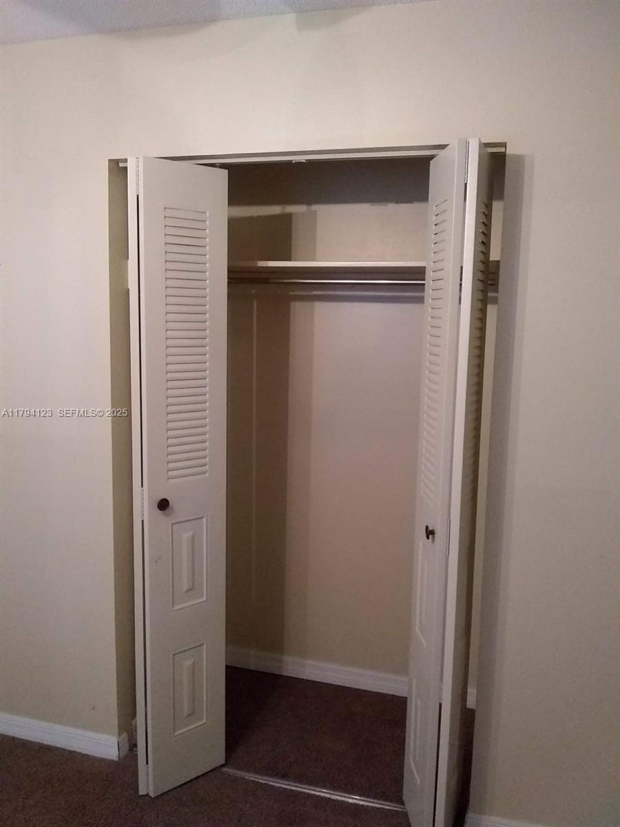 3100-3112 Sanders Road Davenport, FL 33837 - Photo 95 of 100 a view of walk in closet with empty racks