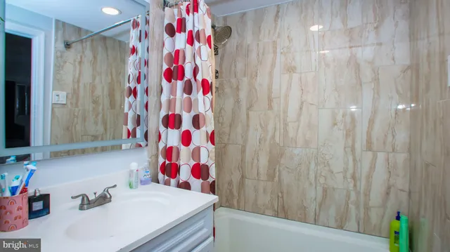 a bathroom with a sink and a shower curtain