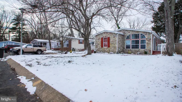 a view of large house with a snow in the yard