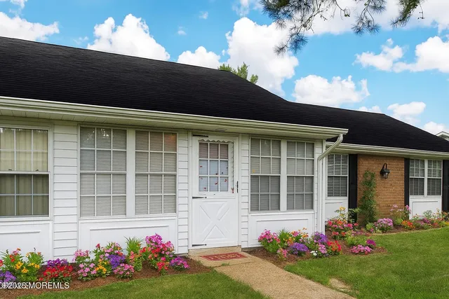 a flower garden is sitting in front of a house