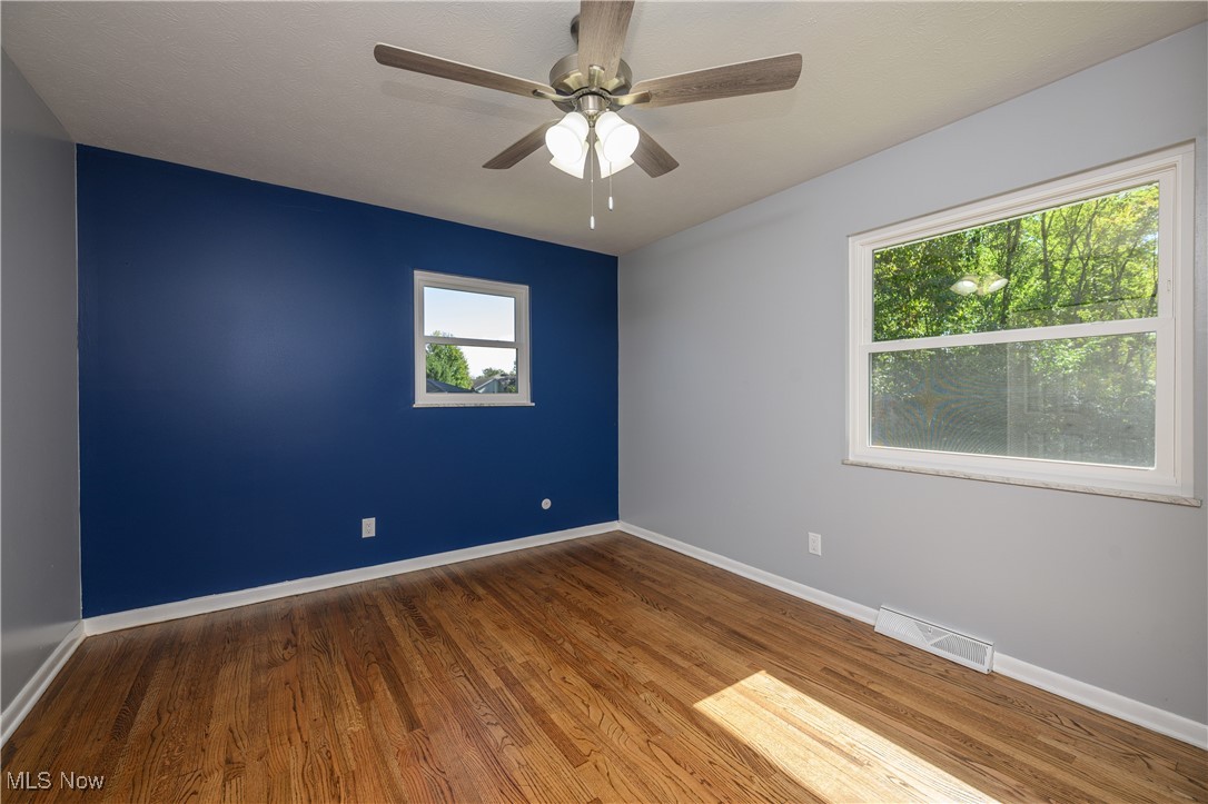 3012 Shellhart Road Barberton, OH 44203 - Photo 22 of 28 Empty room featuring dark wood-style floors and a ceiling fan