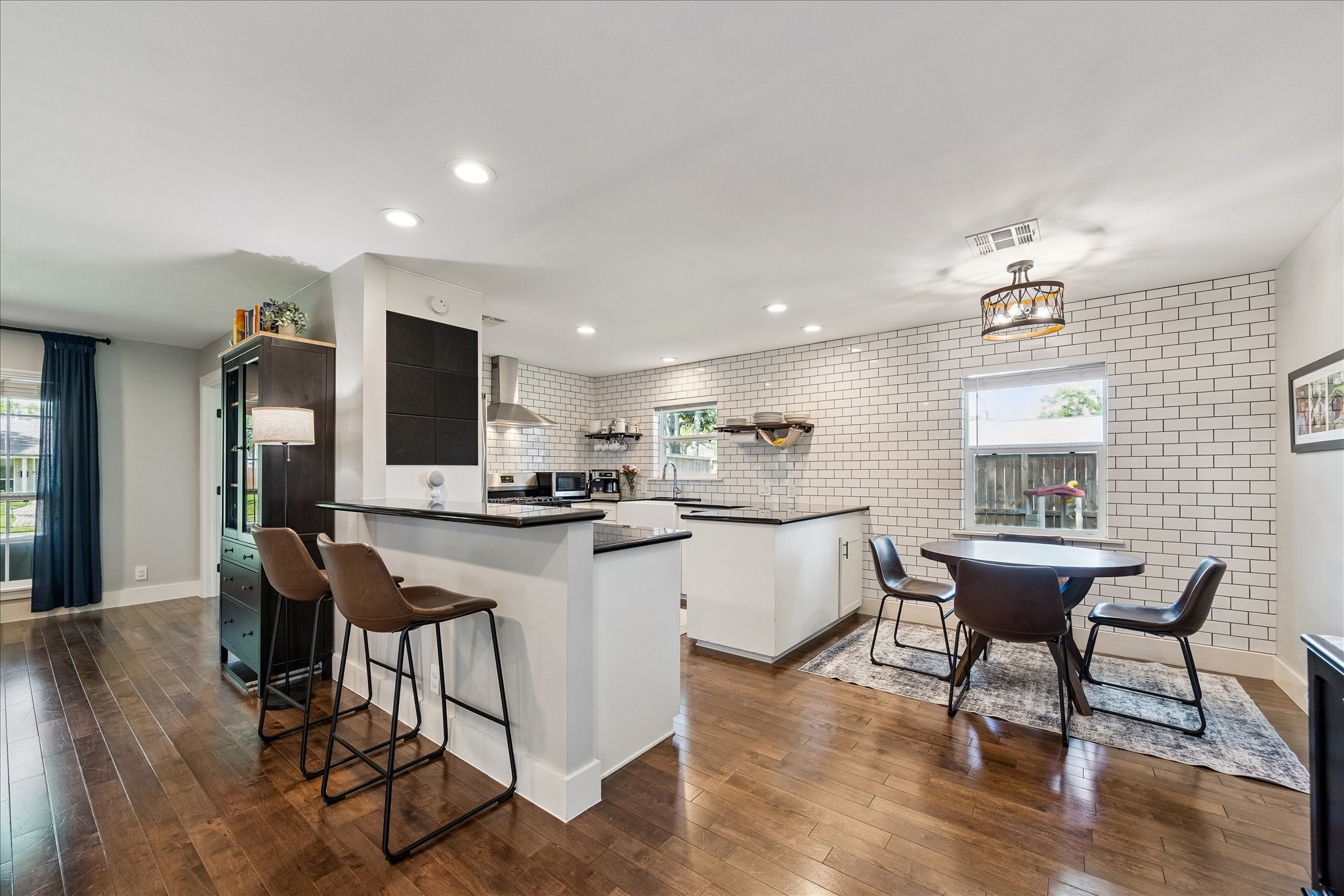 2203 Lamonte Lane Houston, TX 77018 - Photo 5 of 25 a kitchen with stainless steel appliances kitchen island granite countertop a dining table chairs and granite counter tops