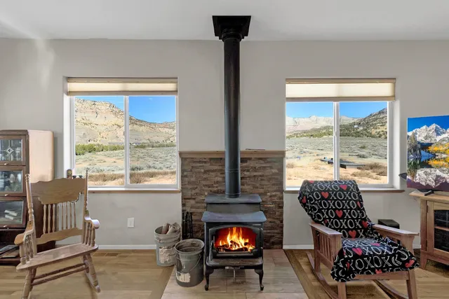 a living room with furniture and a floor to ceiling window