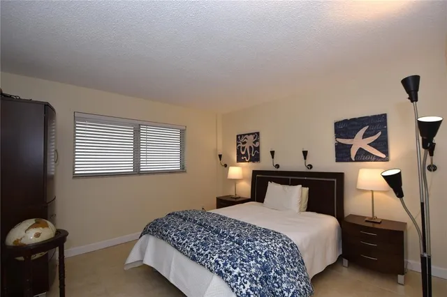 a bedroom with a bed and a lamp