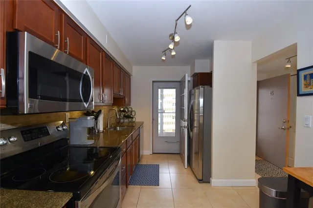 a kitchen with stainless steel appliances a stove a microwave and cabinets