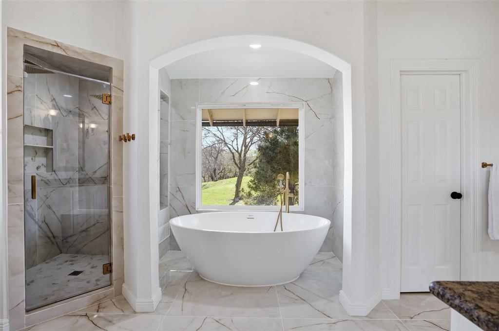 13280 Beach Club Road The Colony, TX 75056 - Photo 15 of 40 a bathroom with a bathtub and shower