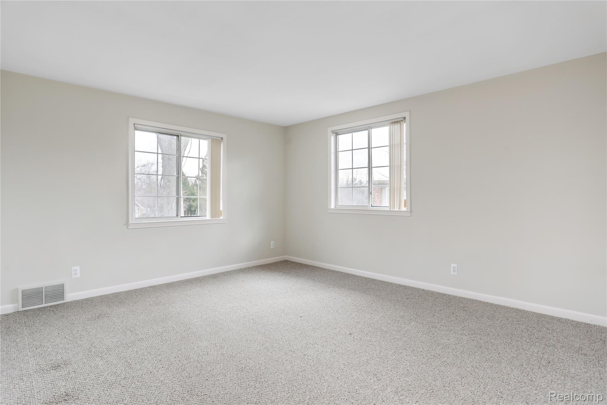 1898 Maple Road East Birmingham, MI 48009 - Photo 6 of 10 Spacious room featuring neutral carpeting and two window units with blinds