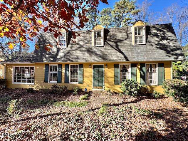 1134 Manchester Drive Cary, NC 27511 - Photo 1 of 15 a front view of a house with garden