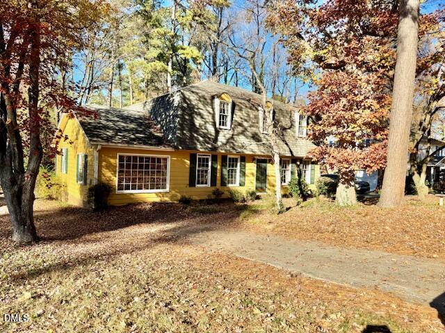 1134 Manchester Drive Cary, NC 27511 - Photo 2 of 15 a view of a house with a yard covered in snow