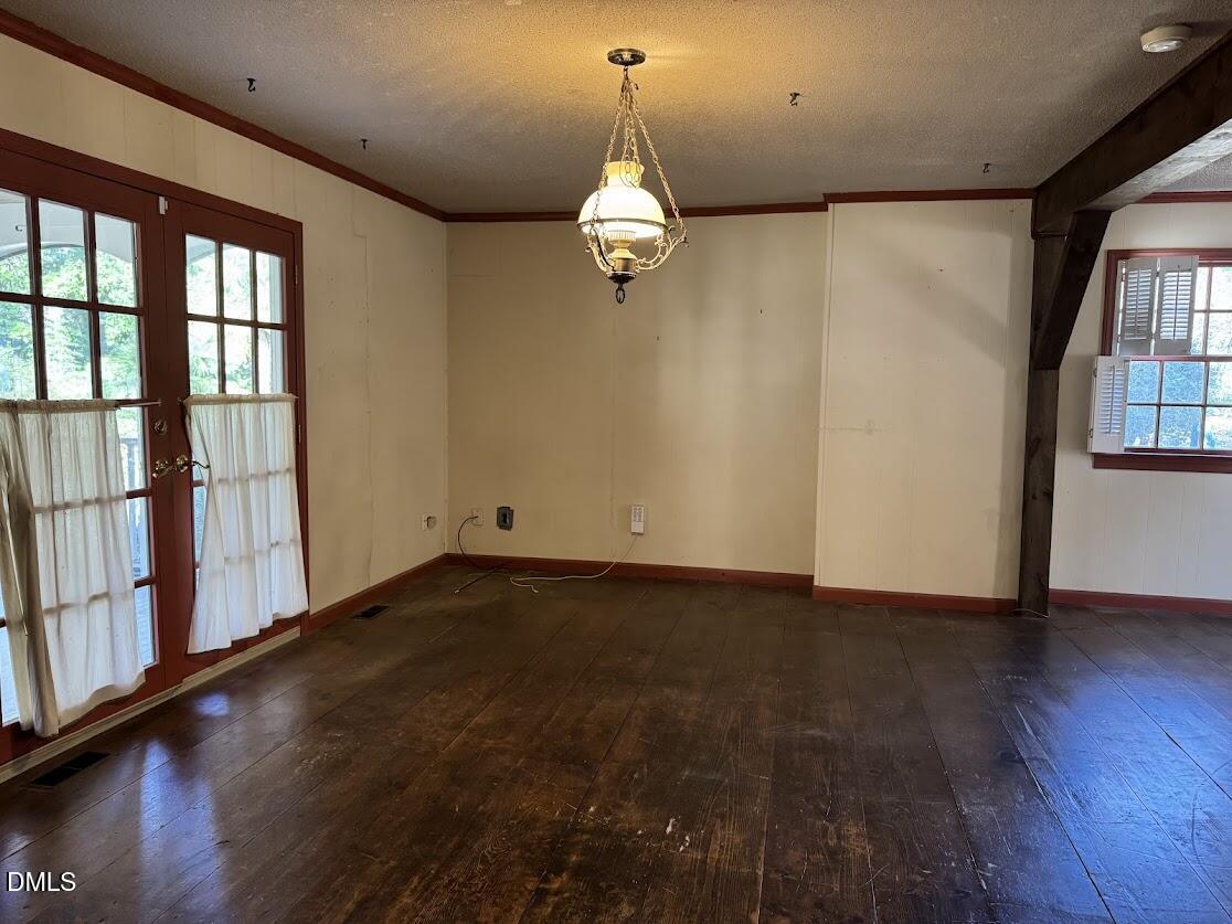 1134 Manchester Drive Cary, NC 27511 - Photo 5 of 15 a view of an empty room with wooden floor and windows