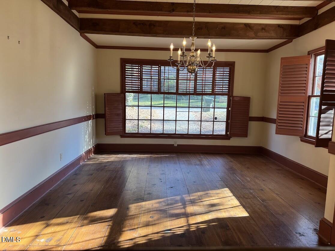 1134 Manchester Drive Cary, NC 27511 - Photo 8 of 15 a view of an empty room with wooden floor and a window