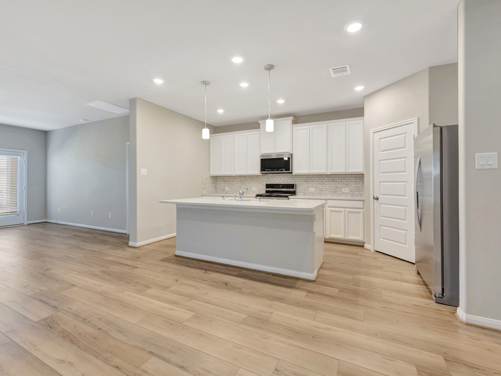 17882 Stone Terrace Montgomery, TX 77316 - Photo 1 of 33 a view of kitchen with kitchen island a sink wooden floor and stainless steel appliances
