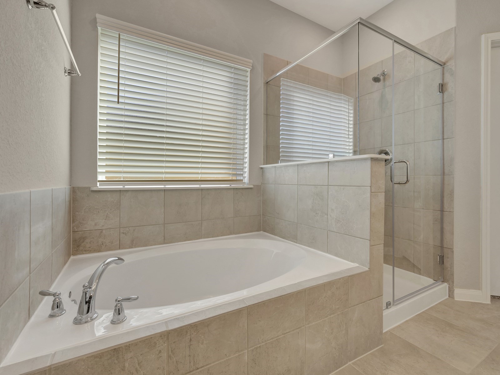 17882 Stone Terrace Montgomery, TX 77316 - Photo 13 of 33 a bathroom with a tub and a shower