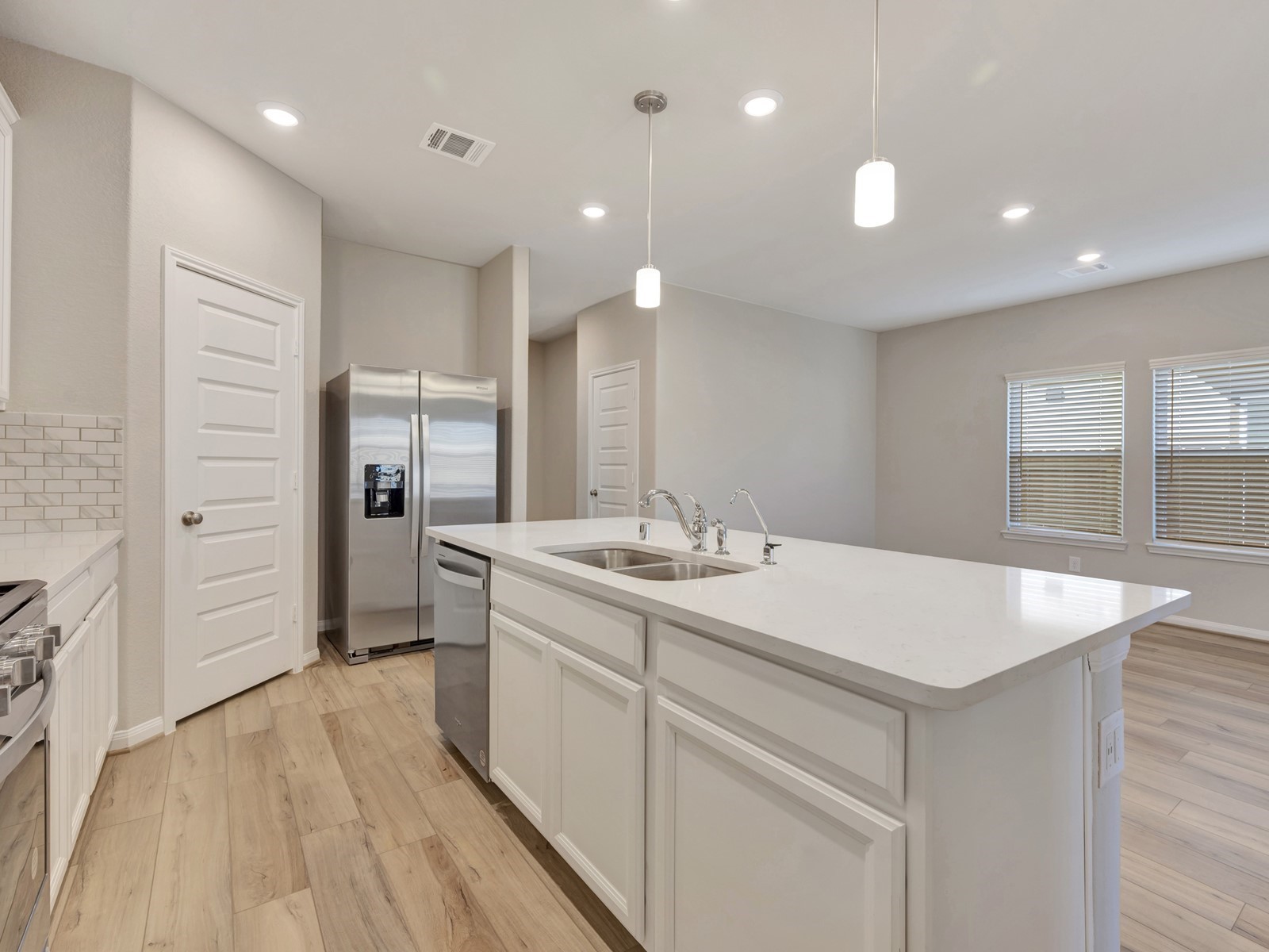 17882 Stone Terrace Montgomery, TX 77316 - Photo 3 of 33 a kitchen with a sink and refrigerator