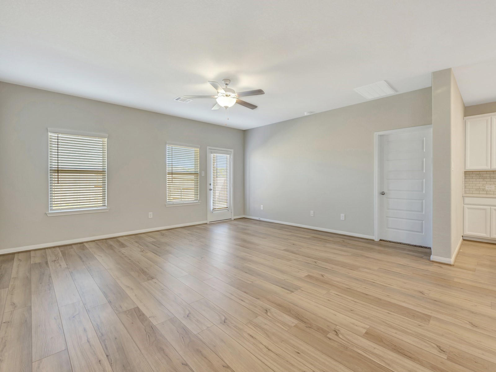 17882 Stone Terrace Montgomery, TX 77316 - Photo 7 of 33 an empty room with wooden floor and windows
