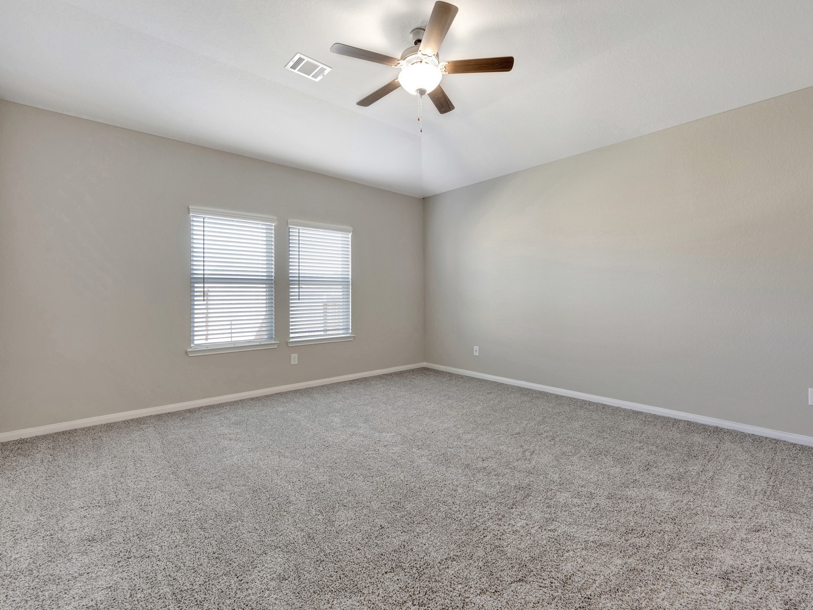 17882 Stone Terrace Montgomery, TX 77316 - Photo 9 of 33 an empty room with windows and ceiling fan