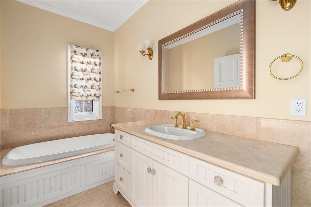 96 Monadnock Road Newton, MA 02467 - Photo 21 of 25 a bathroom with a granite countertop sink mirror vanity bathtub and a toilet