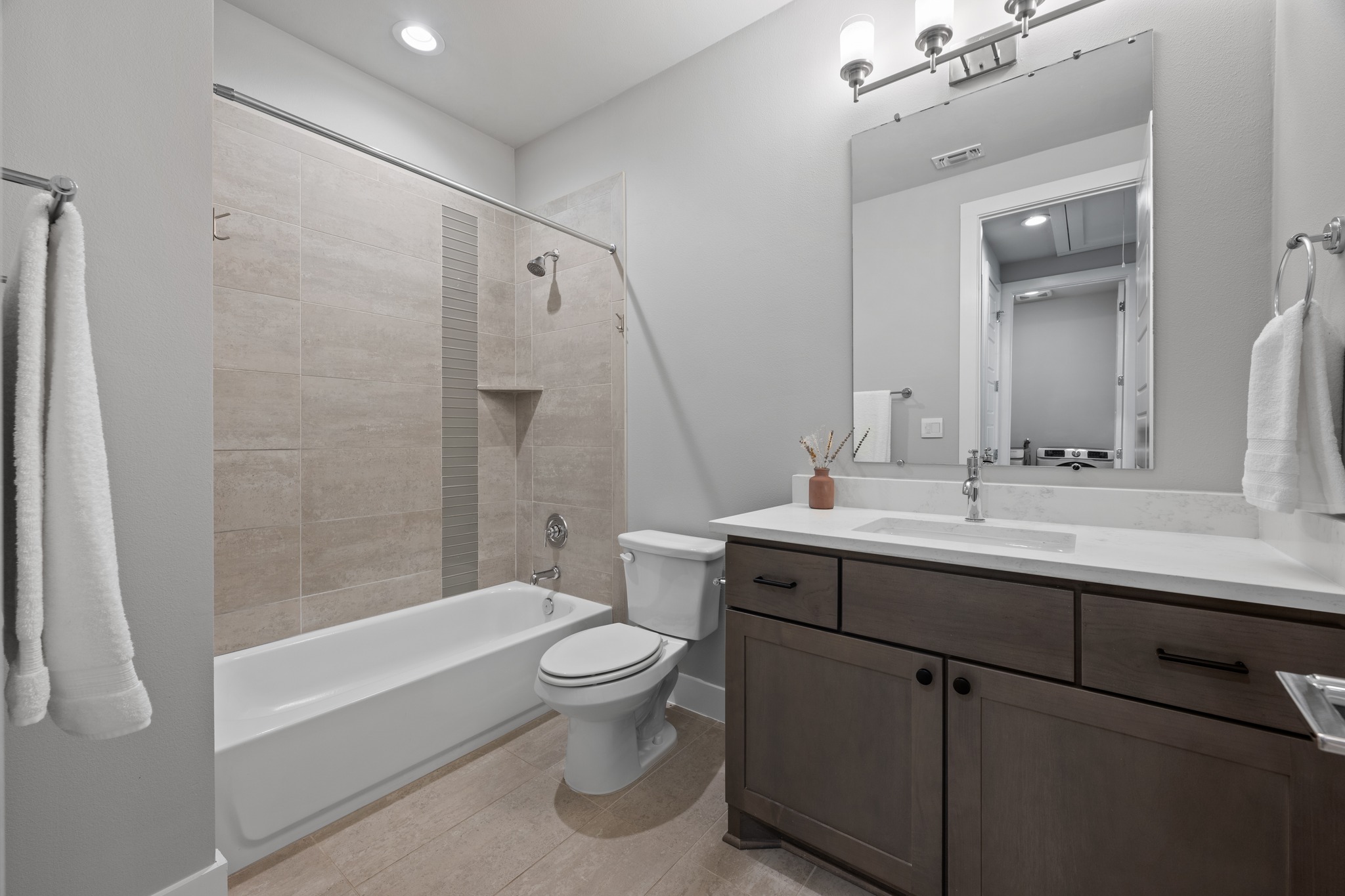 4515 Unity Circle Austin, TX 78731 - Photo 19 of 37 Tiled tub surround and a modern vanity complement the clean lines of this bathroom.