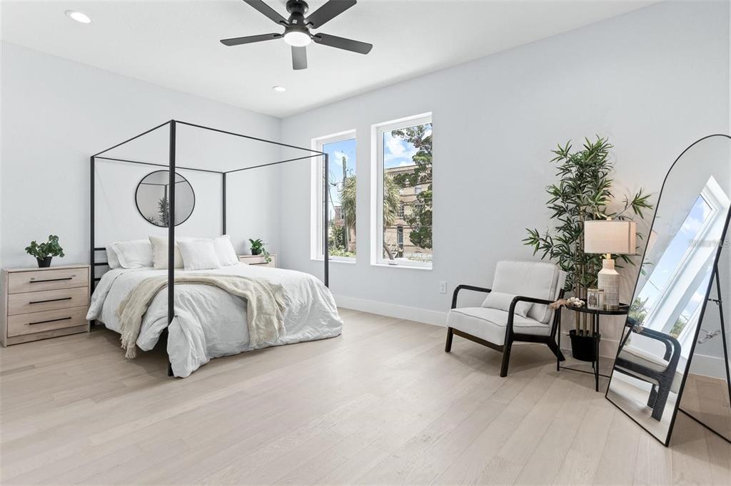 2512 West Chestnut Street Tampa, FL 33607 - Photo 6 of 11 a bedroom with a bed a couch and a chandelier