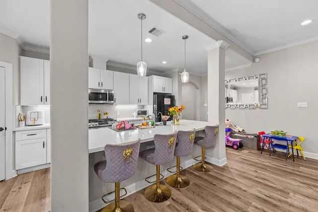 a living room with kitchen island furniture and a wooden floor