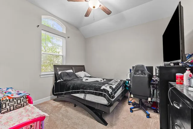 a bedroom with a bed and a chandelier