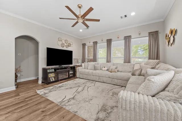 a living room with furniture and a flat screen tv