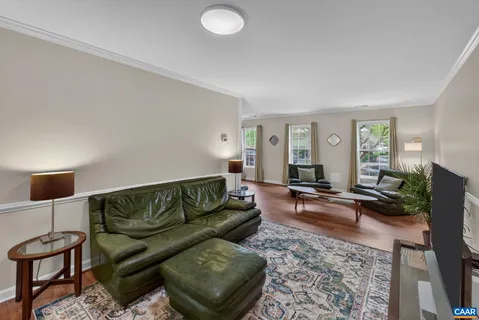 a living room with furniture a rug and a window