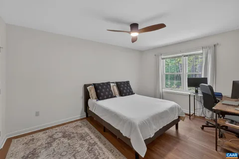 a large bed sitting in a bedroom next to a window