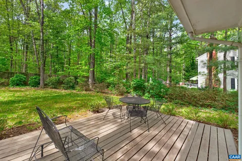 a view of backyard with seating area and green space