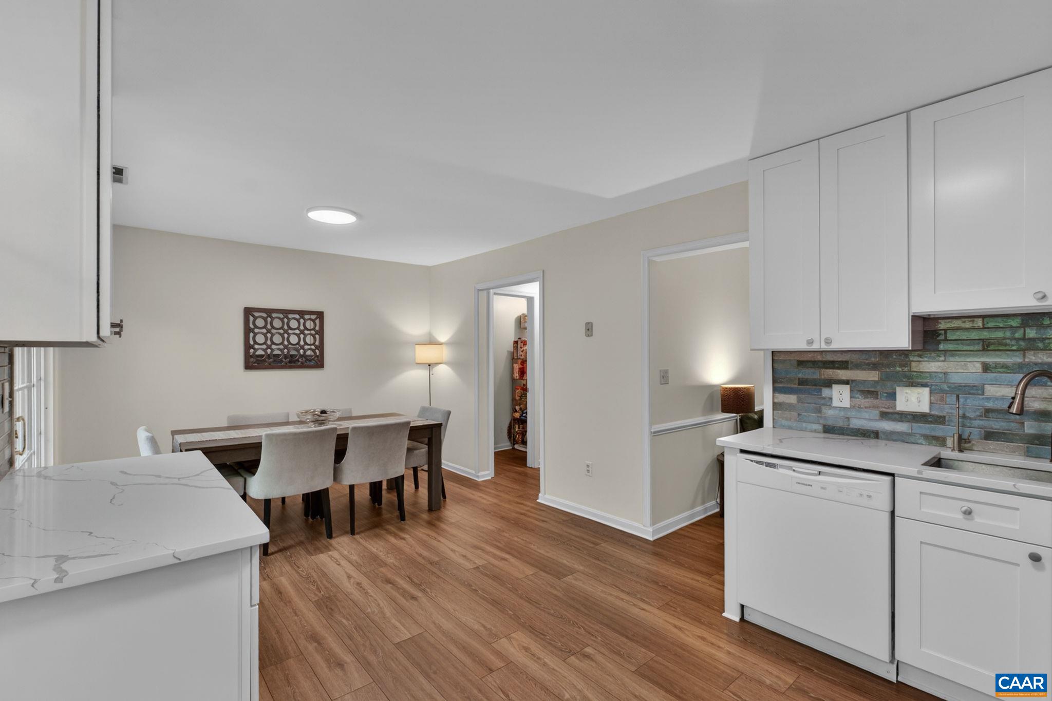 326 Westfield Road Charlottesville, VA 22901 - Photo 8 of 36 a kitchen with a sink a stove cabinets and wooden floor