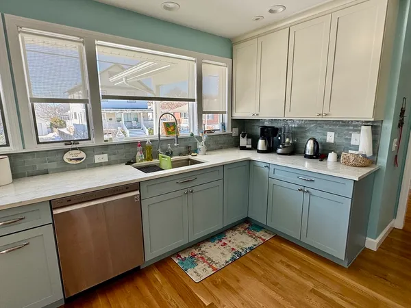 a kitchen with a sink cabinets and window
