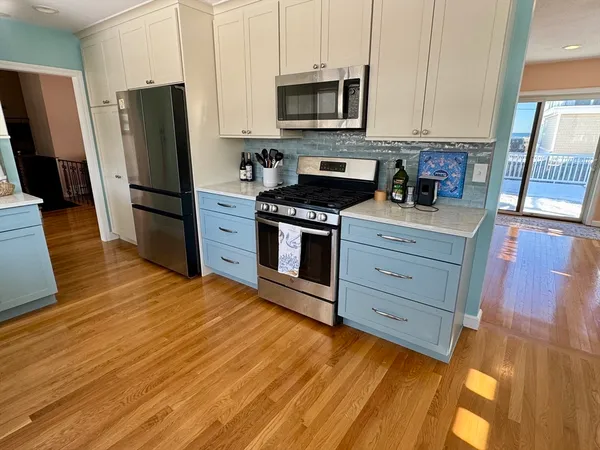 a kitchen with stainless steel appliances granite countertop a refrigerator stove and sink