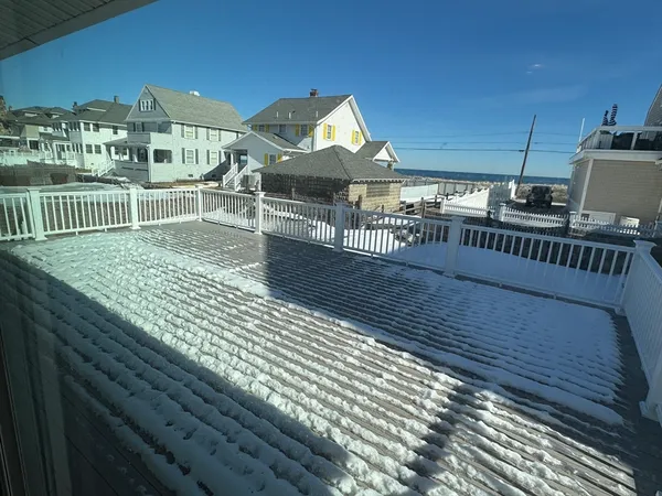 a view of a balcony with wooden floor