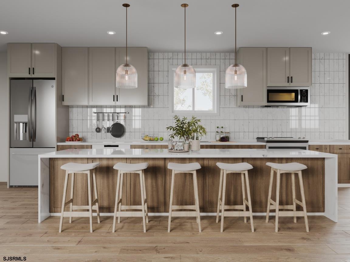 604 9th Street Somers Point, NJ 08244 - Photo 5 of 6 a kitchen with a sink cabinets and wooden floor